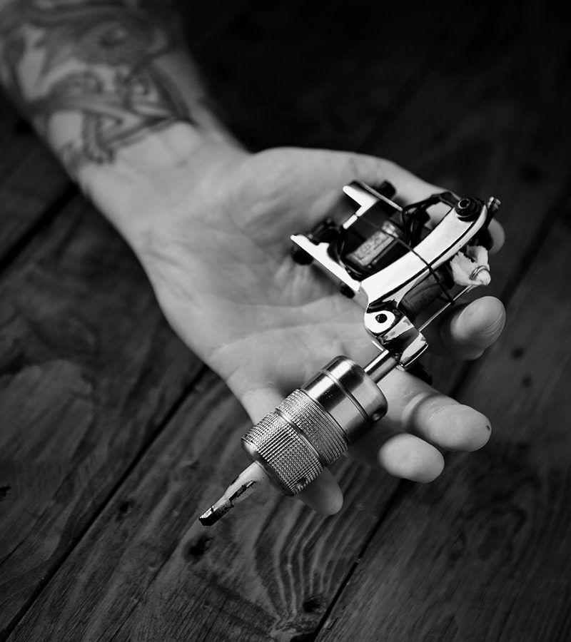 close up of a mans hand with tattoo gun 298DBHB.jpg